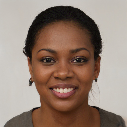 Joyful black young-adult female with short  black hair and brown eyes
