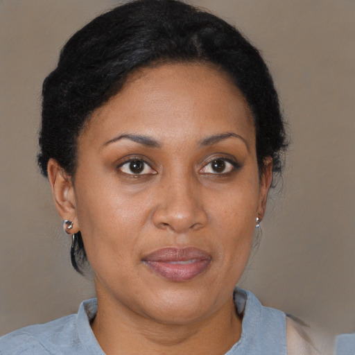 Joyful black adult female with short  brown hair and brown eyes