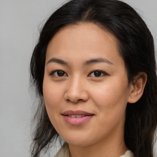 Joyful asian young-adult female with long  brown hair and brown eyes