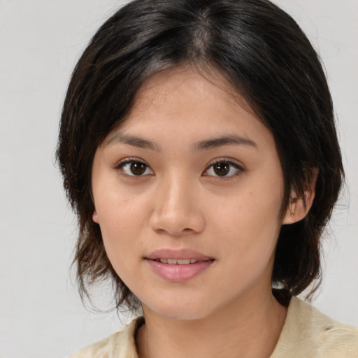 Joyful white young-adult female with medium  brown hair and brown eyes