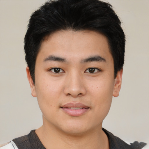 Joyful asian young-adult male with short  black hair and brown eyes