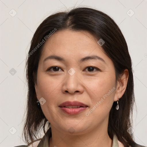 Joyful white adult female with medium  brown hair and brown eyes