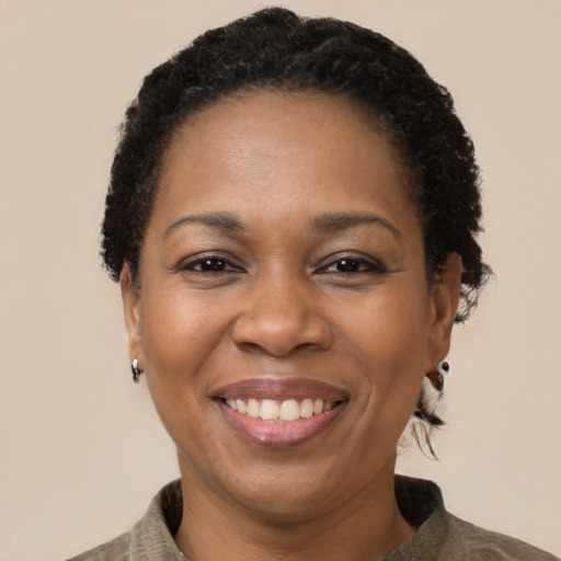 Joyful black adult female with short  brown hair and brown eyes