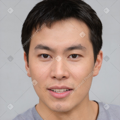 Joyful asian young-adult male with short  brown hair and brown eyes