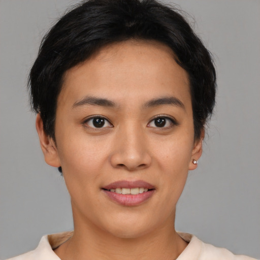 Joyful asian young-adult female with short  brown hair and brown eyes