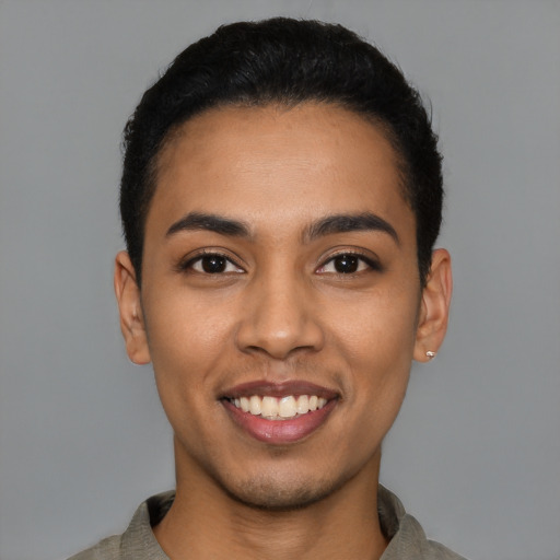 Joyful latino young-adult male with short  black hair and brown eyes