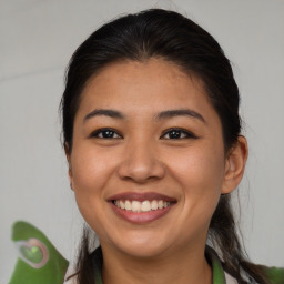 Joyful asian young-adult female with long  brown hair and brown eyes