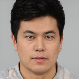 Neutral asian young-adult male with short  brown hair and brown eyes