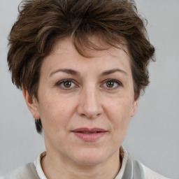 Joyful white adult female with short  brown hair and brown eyes