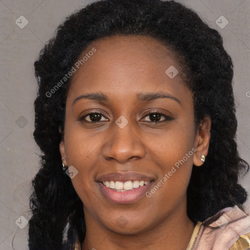 Joyful black young-adult female with long  black hair and brown eyes