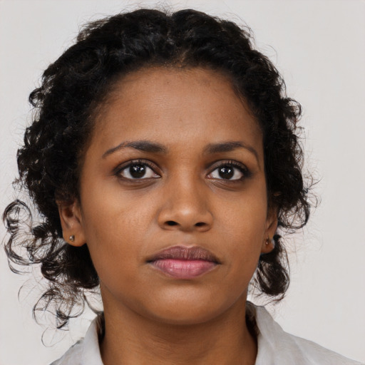 Neutral black young-adult female with medium  brown hair and brown eyes