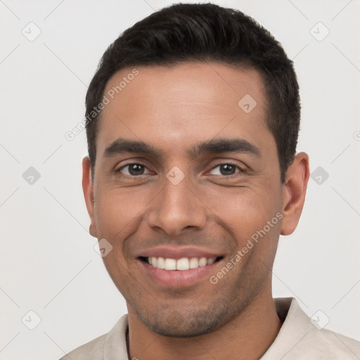 Joyful white young-adult male with short  black hair and brown eyes