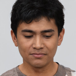 Joyful asian young-adult male with short  black hair and brown eyes