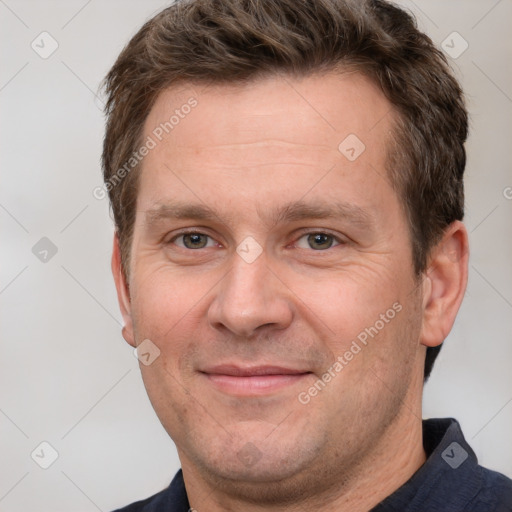 Joyful white adult male with short  brown hair and grey eyes