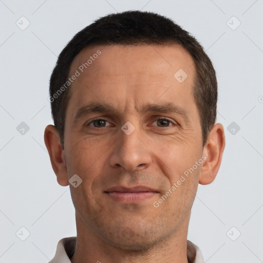 Joyful white adult male with short  brown hair and brown eyes