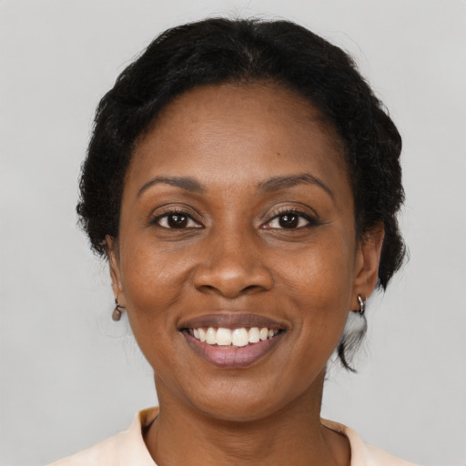 Joyful black adult female with medium  brown hair and brown eyes
