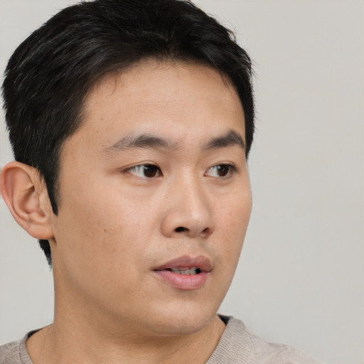 Neutral asian young-adult male with short  brown hair and brown eyes