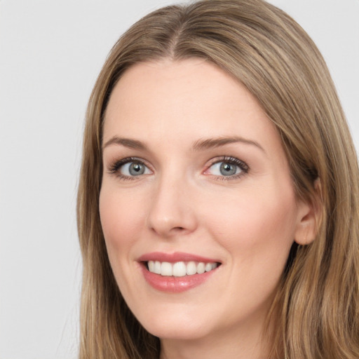 Joyful white young-adult female with long  brown hair and green eyes