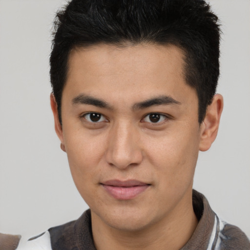Joyful latino young-adult male with short  brown hair and brown eyes