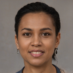 Joyful latino young-adult female with short  brown hair and brown eyes