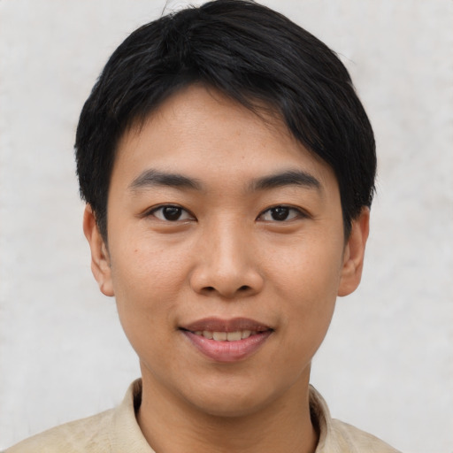 Joyful asian young-adult male with short  black hair and brown eyes