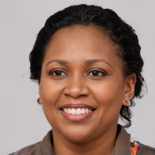Joyful black young-adult female with medium  brown hair and brown eyes