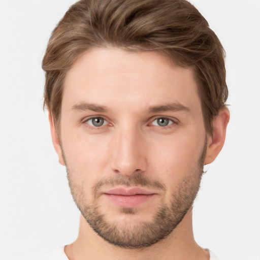 Joyful white young-adult male with short  brown hair and grey eyes