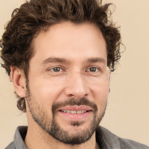 Joyful white adult male with short  brown hair and brown eyes