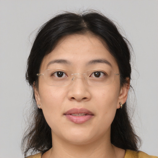 Joyful asian adult female with medium  brown hair and brown eyes