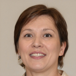 Joyful white adult female with medium  brown hair and brown eyes