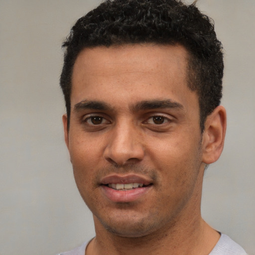 Joyful white young-adult male with short  black hair and brown eyes