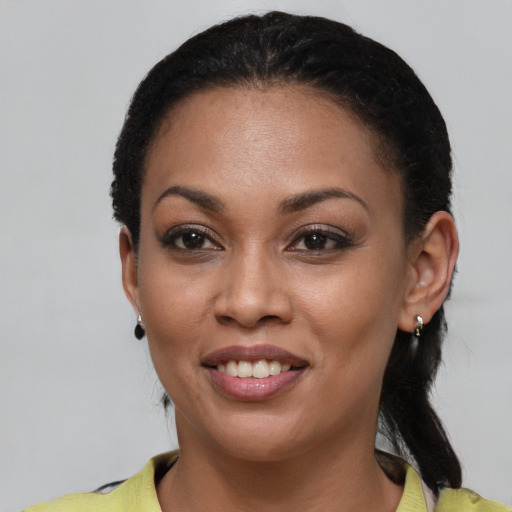 Joyful latino young-adult female with short  black hair and brown eyes