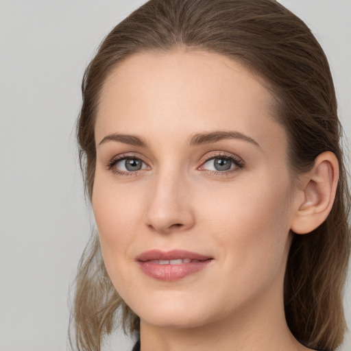 Joyful white young-adult female with long  brown hair and grey eyes