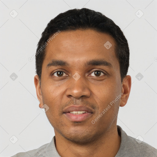 Joyful black young-adult male with short  black hair and brown eyes