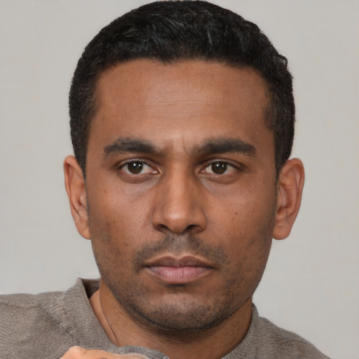 Neutral latino young-adult male with short  black hair and brown eyes