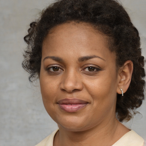 Joyful black young-adult female with medium  brown hair and brown eyes