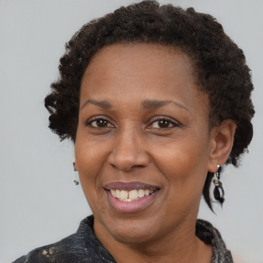 Joyful black adult female with short  brown hair and brown eyes