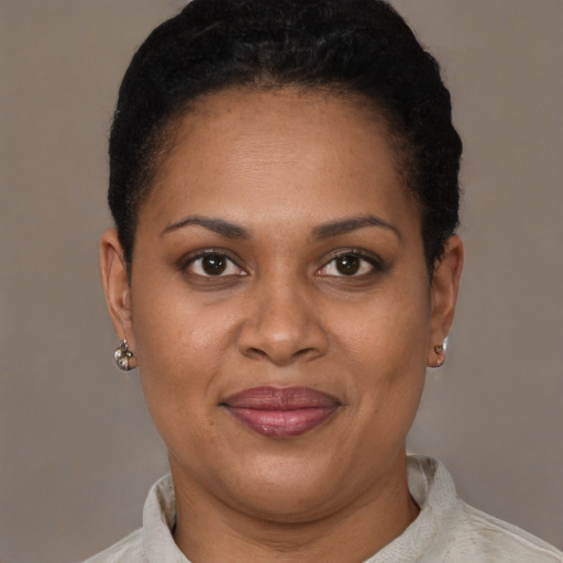 Joyful latino adult female with short  brown hair and brown eyes