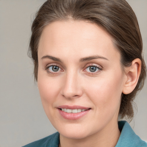 Joyful white young-adult female with medium  brown hair and blue eyes