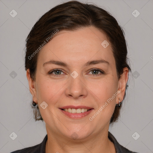 Joyful white adult female with medium  brown hair and grey eyes