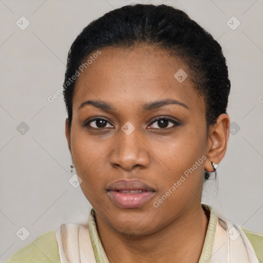 Joyful black young-adult female with short  black hair and brown eyes