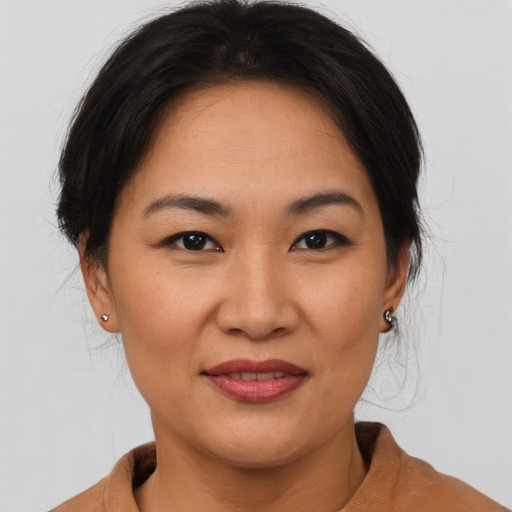 Joyful asian young-adult female with medium  brown hair and brown eyes
