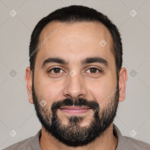 Joyful white adult male with short  black hair and brown eyes