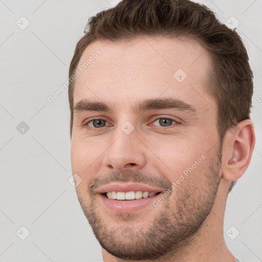 Joyful white young-adult male with short  brown hair and brown eyes