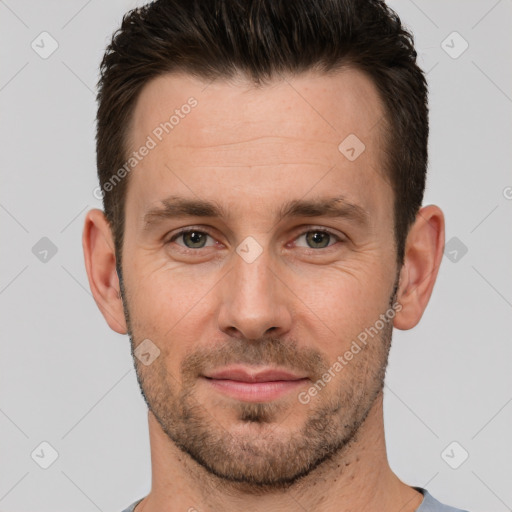 Joyful white young-adult male with short  brown hair and brown eyes