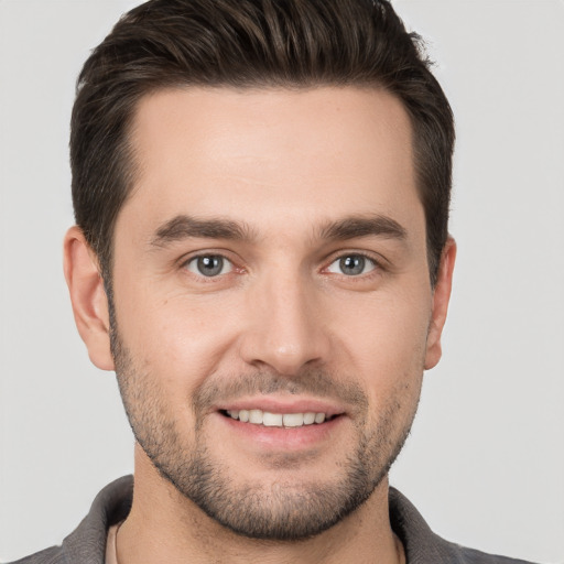 Joyful white young-adult male with short  brown hair and brown eyes