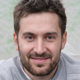 Joyful white adult male with short  brown hair and brown eyes