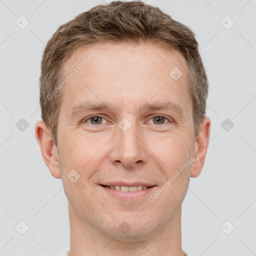 Joyful white adult male with short  brown hair and grey eyes