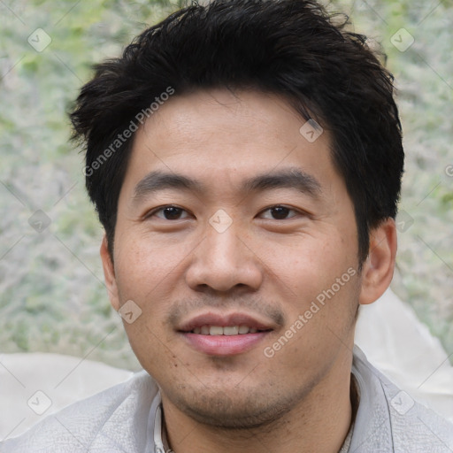 Joyful asian young-adult male with short  black hair and brown eyes