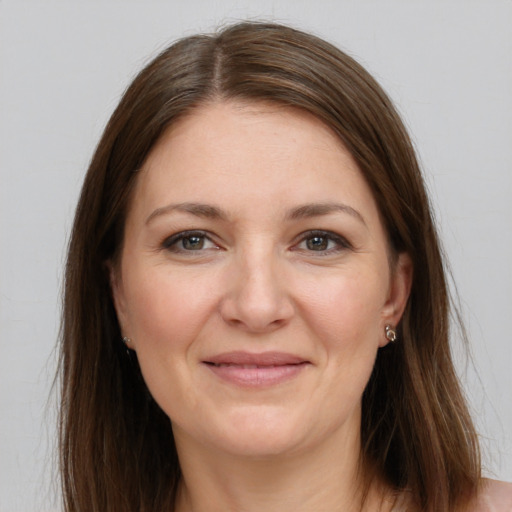 Joyful white young-adult female with long  brown hair and grey eyes